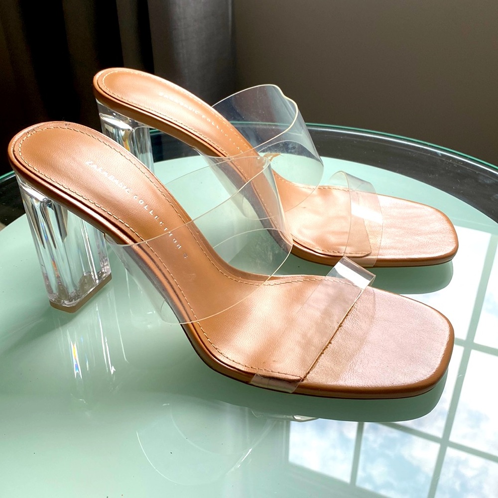 Sandal with lucite heel and clear straps.